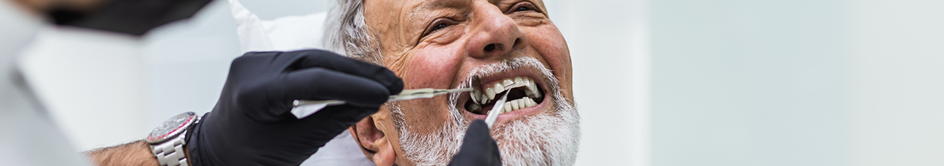 Senior man in the dental chair smiling