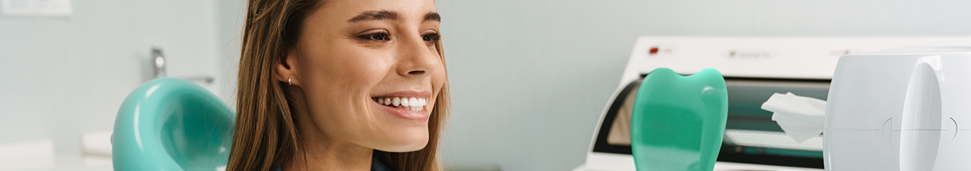 Woman looking at her smile in a mirror