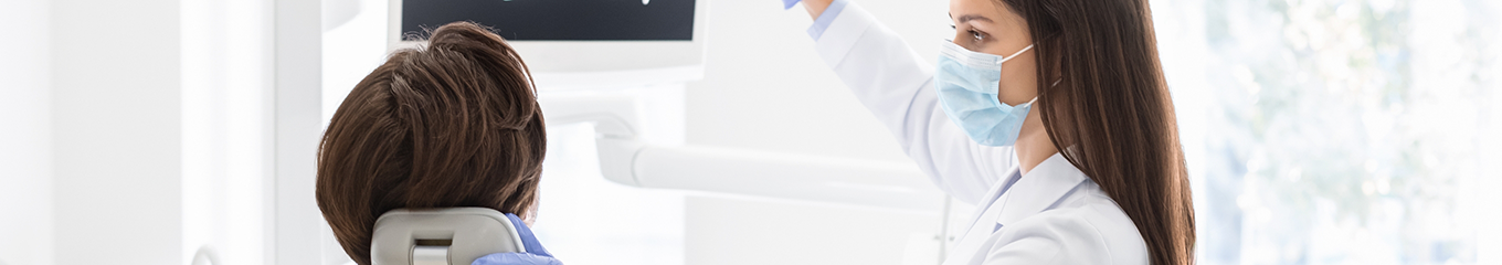 Dentist talking with a patient in the treatment chair