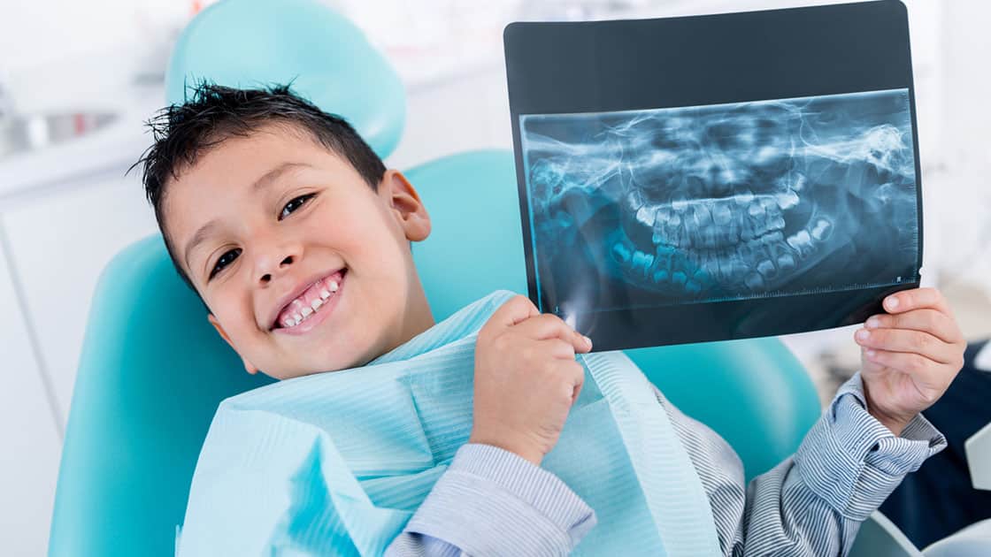 Restorative Pediatric Dentistry Patient Holding X-ray